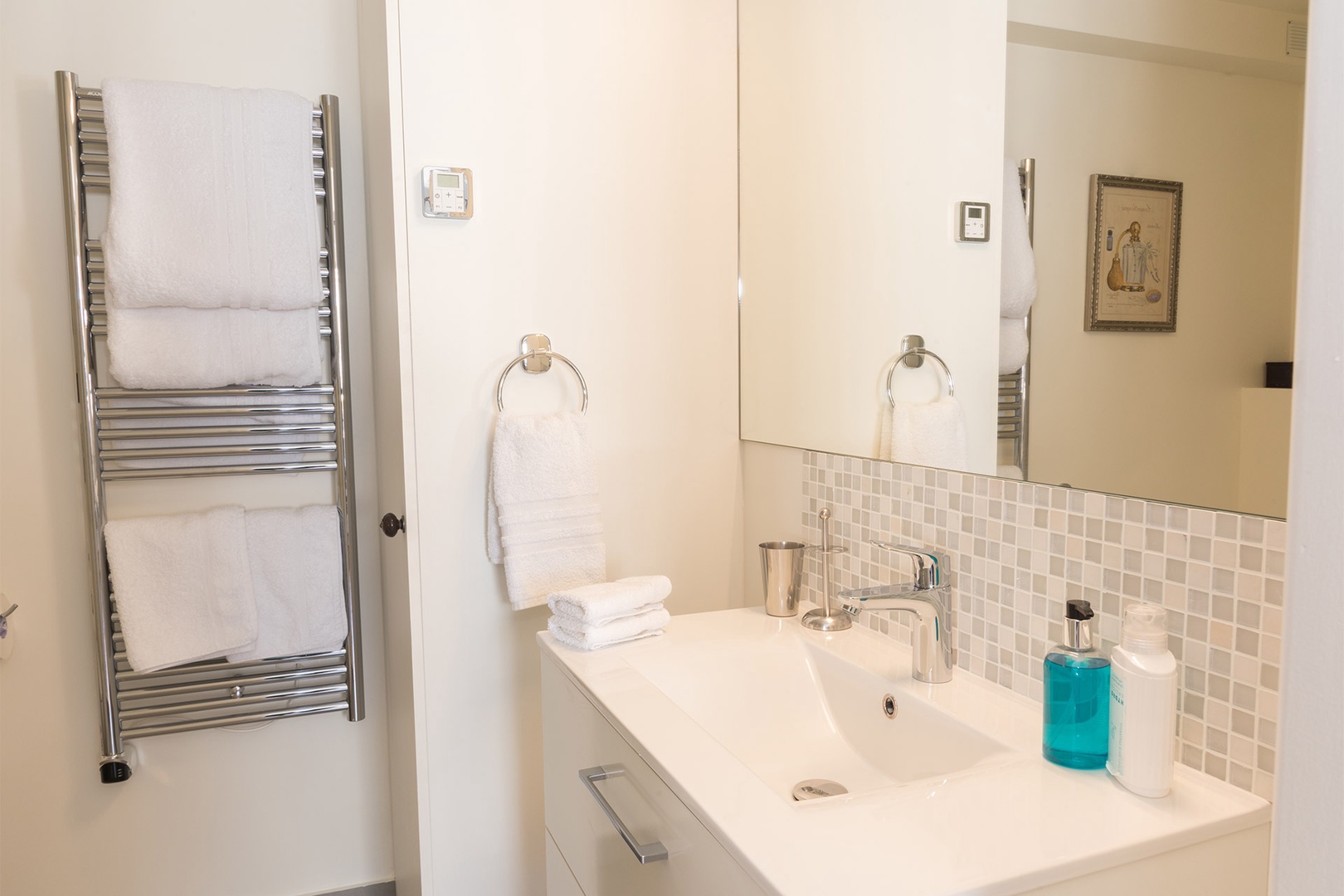 The stylish bathroom comes with a large and comfortable shower.