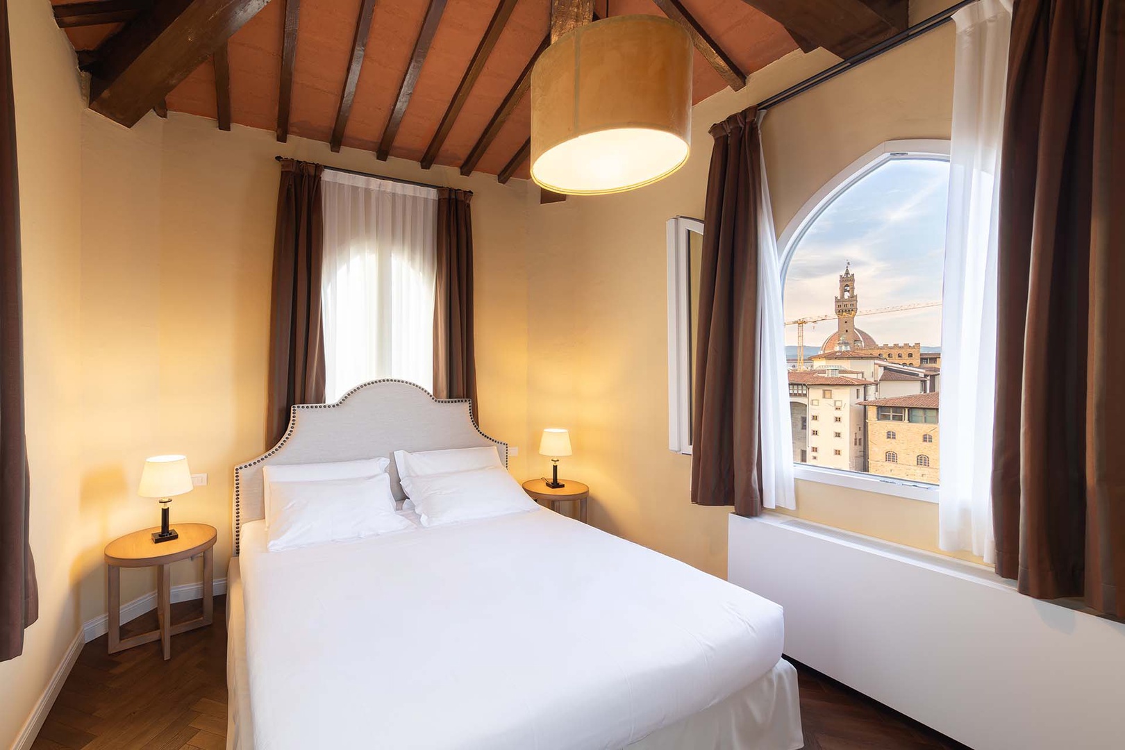 The bedroom window frames views of the Duomo, Palazzo Vecchio and Uffizi gallery.