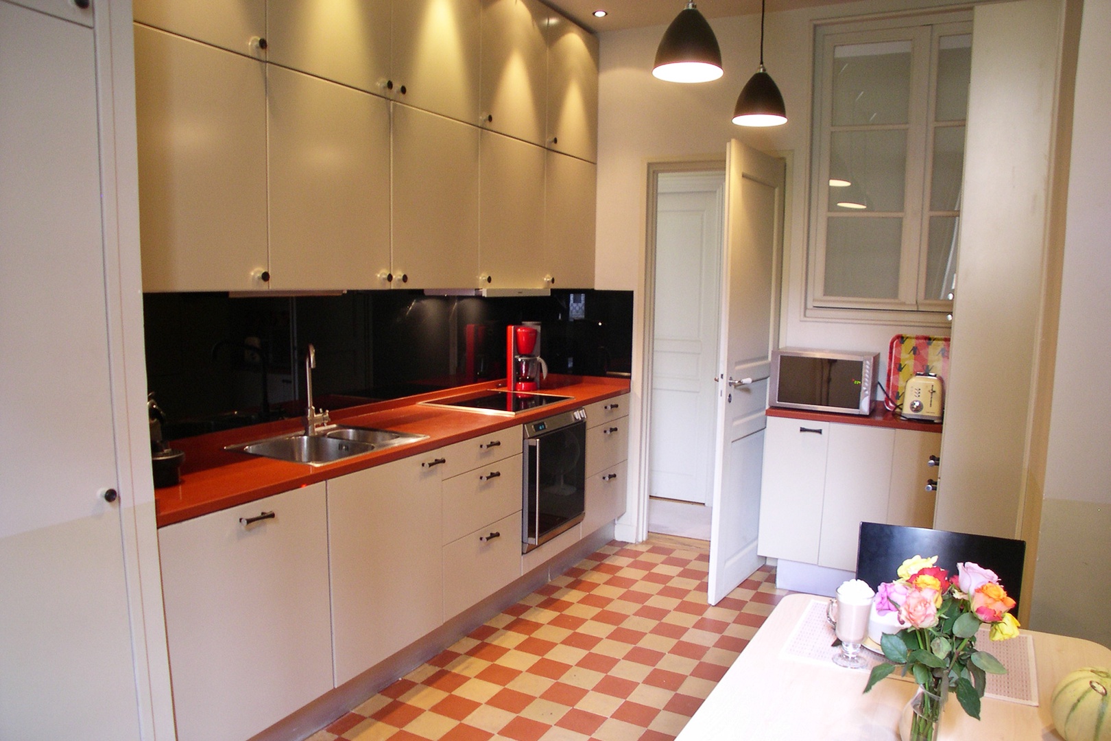 Enjoy cooking in this elegant kitchen with stylish checkerboard tiles.