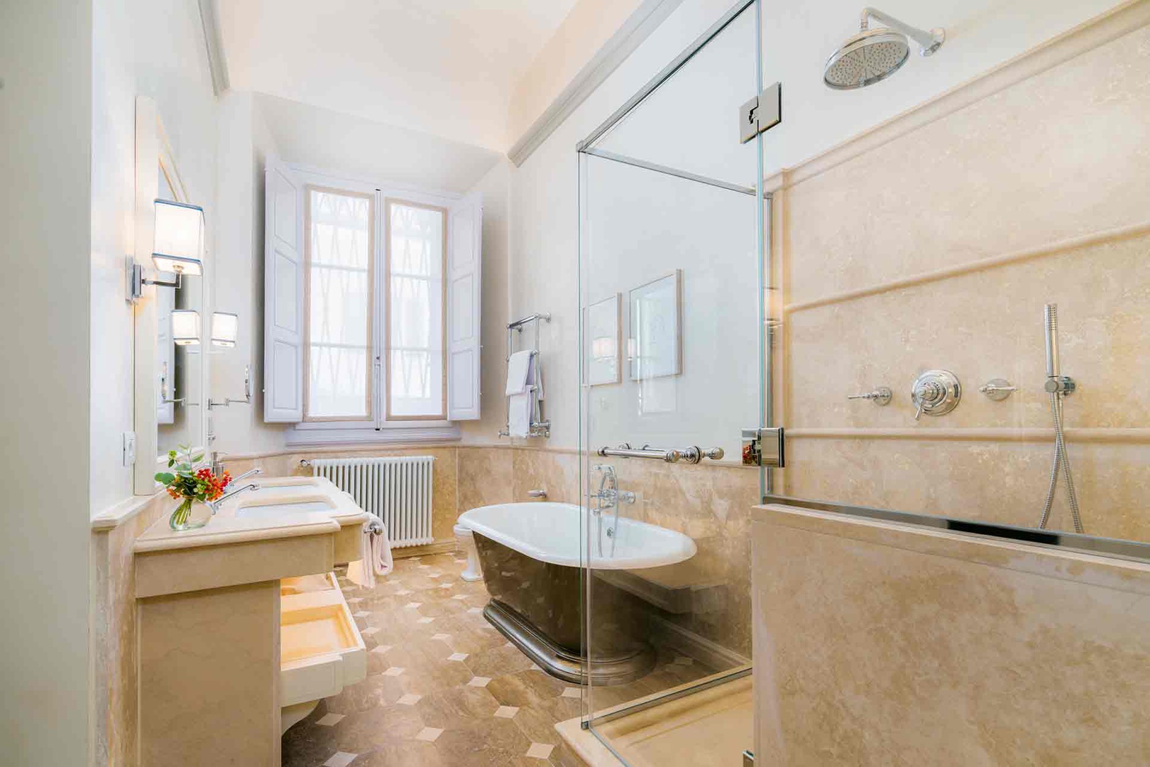 Sink into a luxurious freestanding tub or refresh under your spacious rainfall shower .
