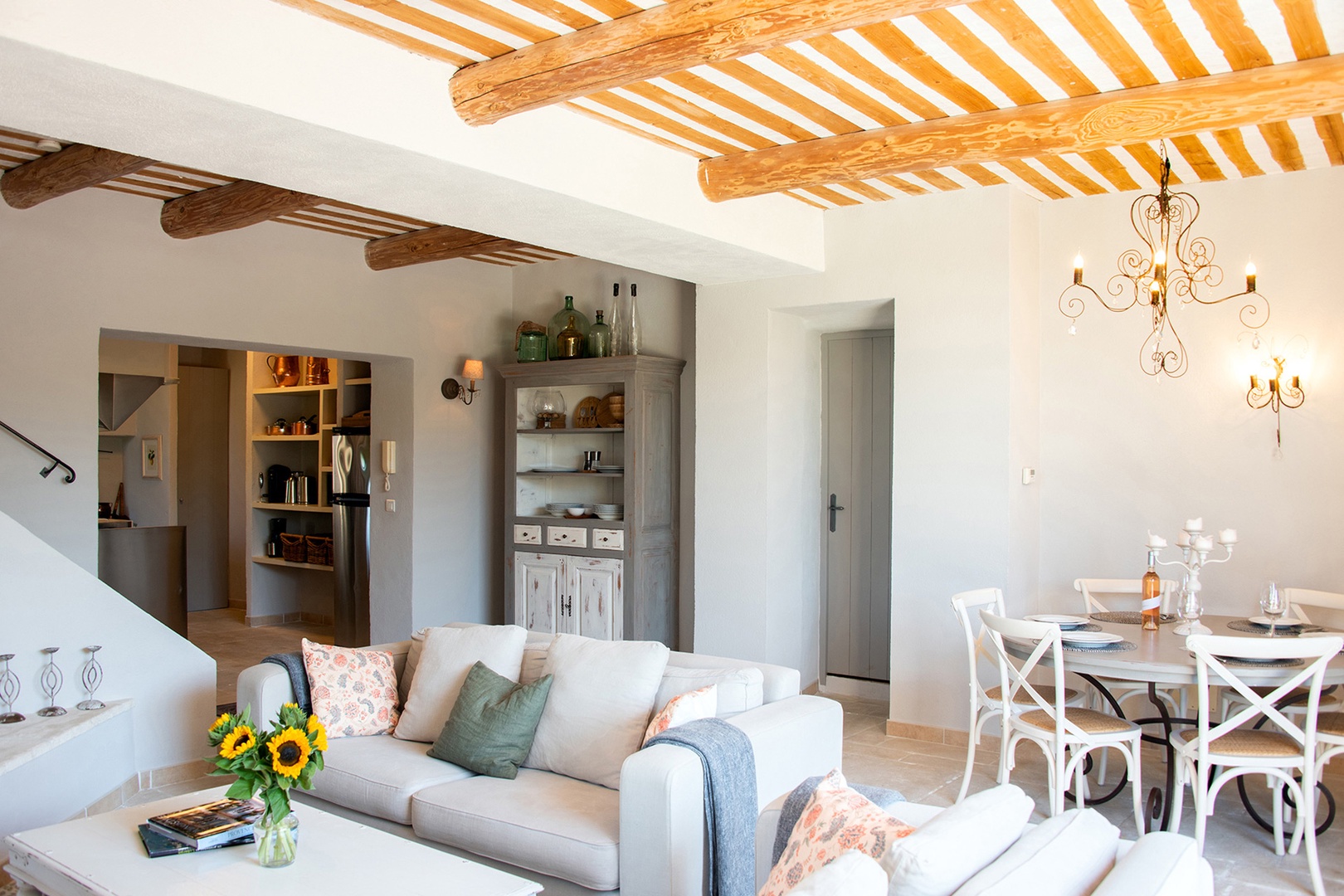 Open plan living room with dining area and kitchen nearby.