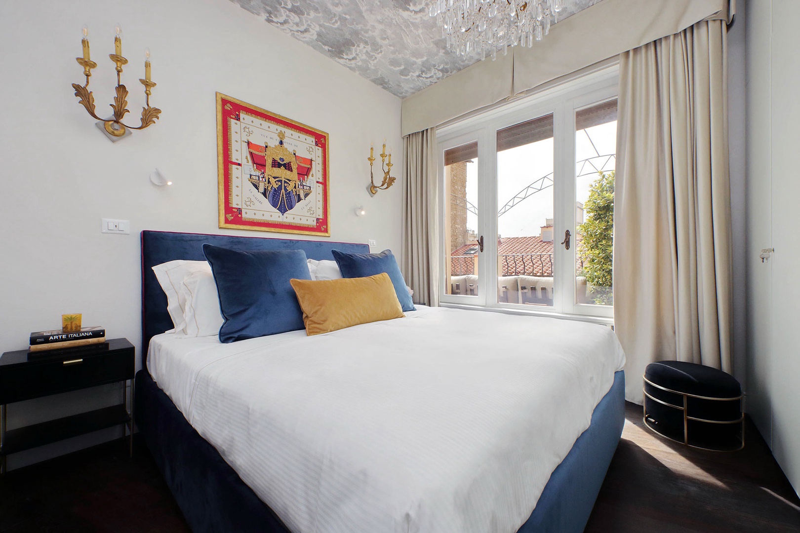 Bedroom 1 has a large bed and a stunning decorative ceiling.