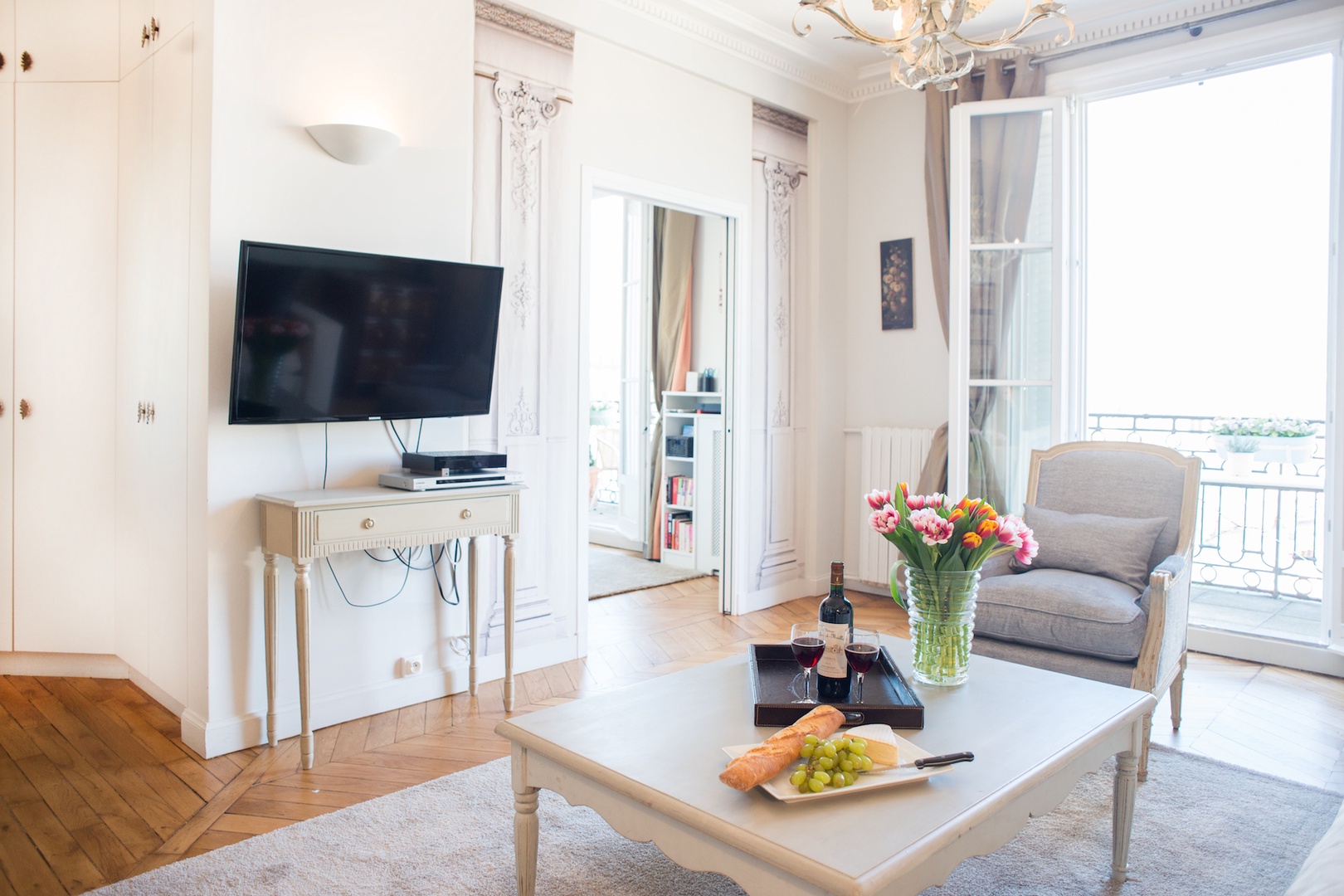 French doors in the living room open to the balcony.