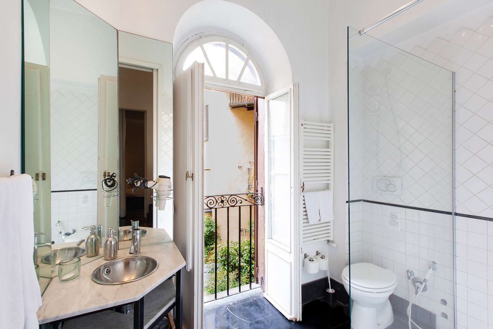 This sparkling bathroom 2 has a modern sink mounted on a glass counter.