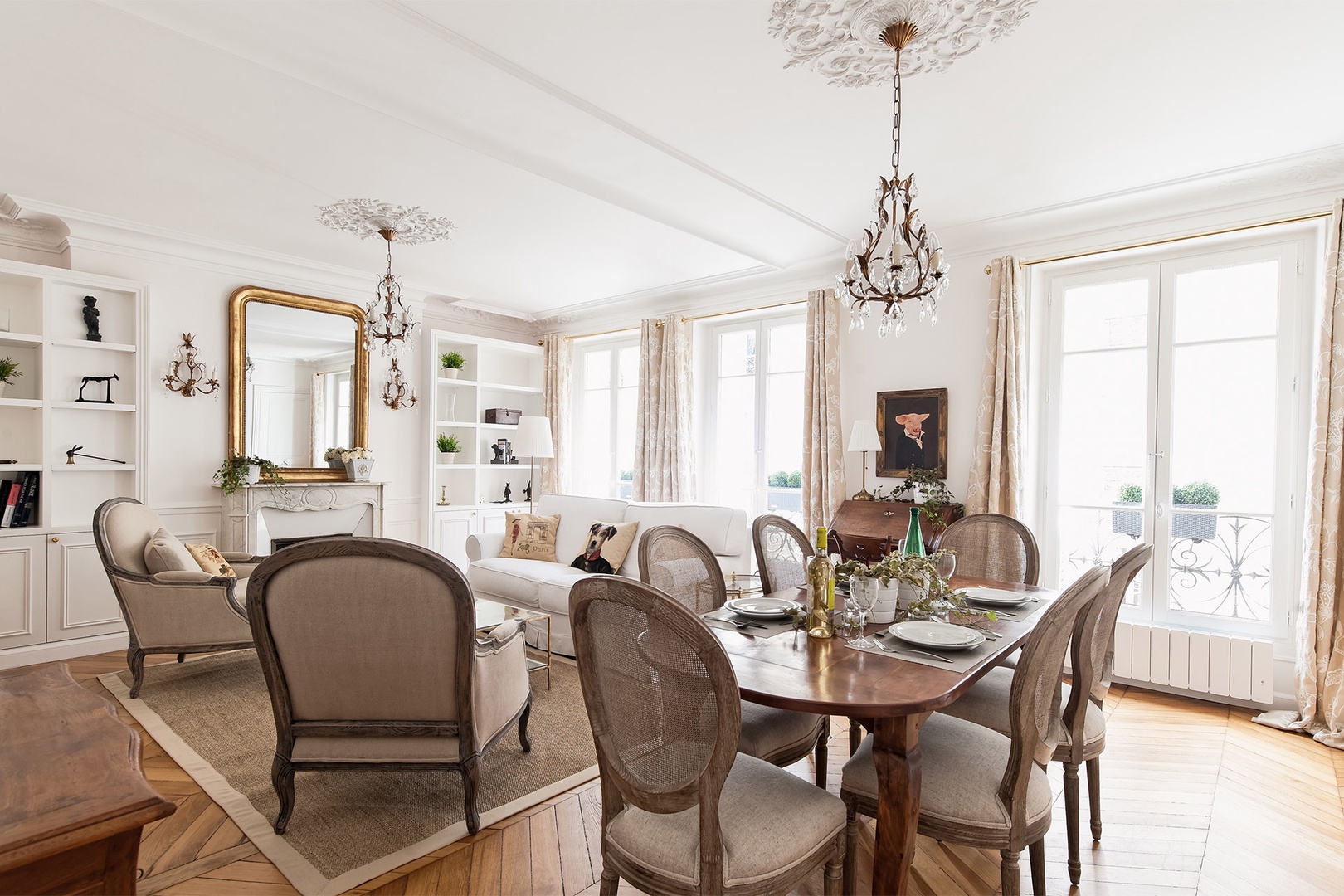 Wooden furnishings and crystal chandeliers adorn the stylish space.