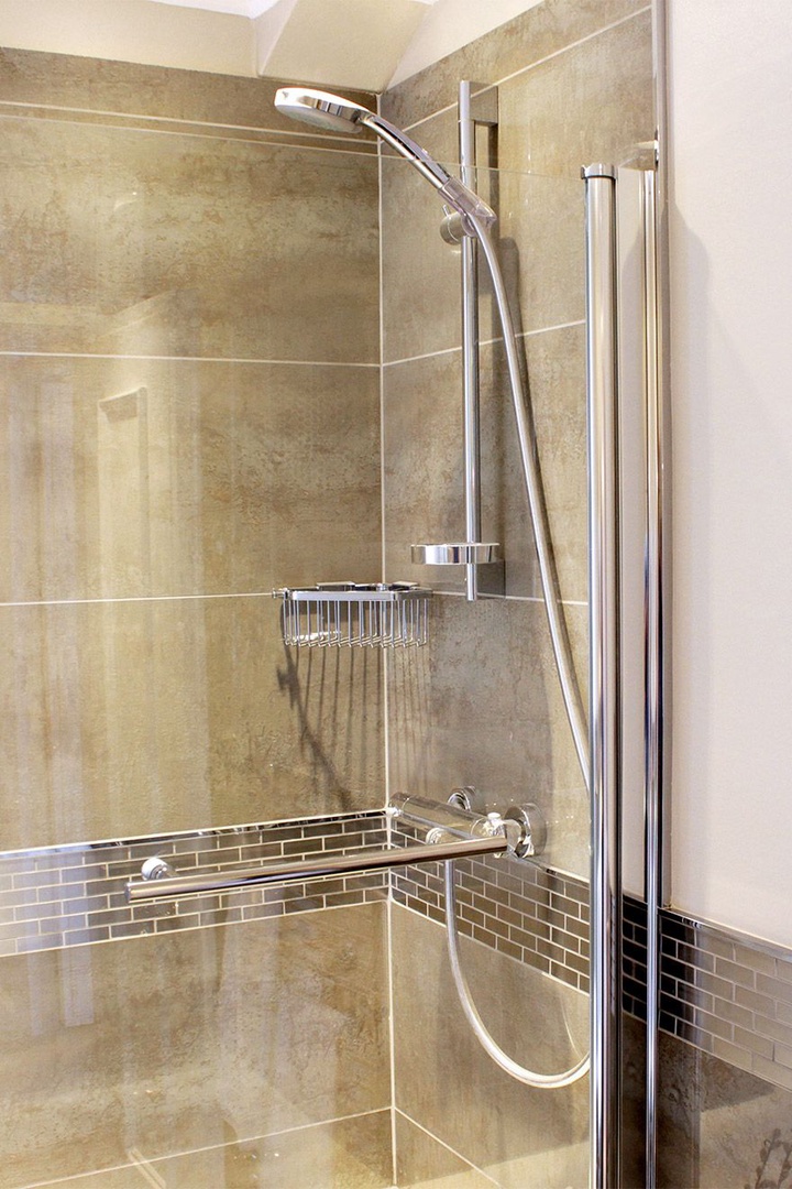 Shower over bathtub with a glass partition
