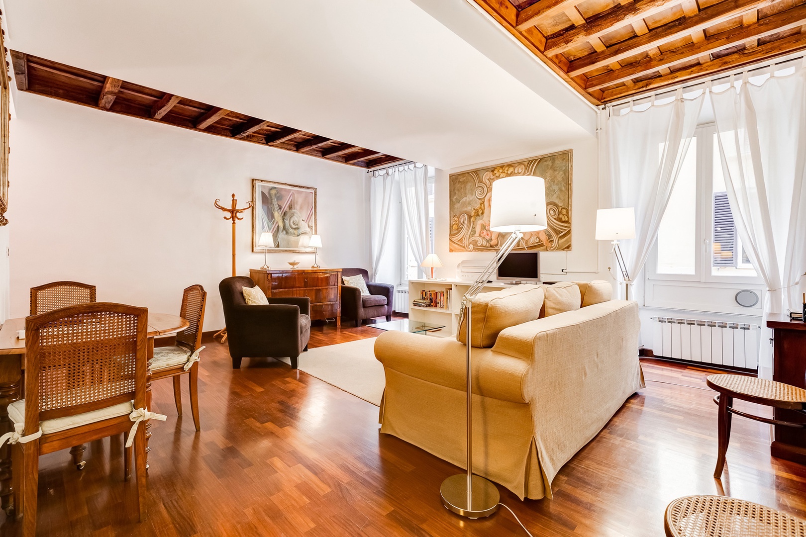 Living room has two very large windows overlooking the small street below.