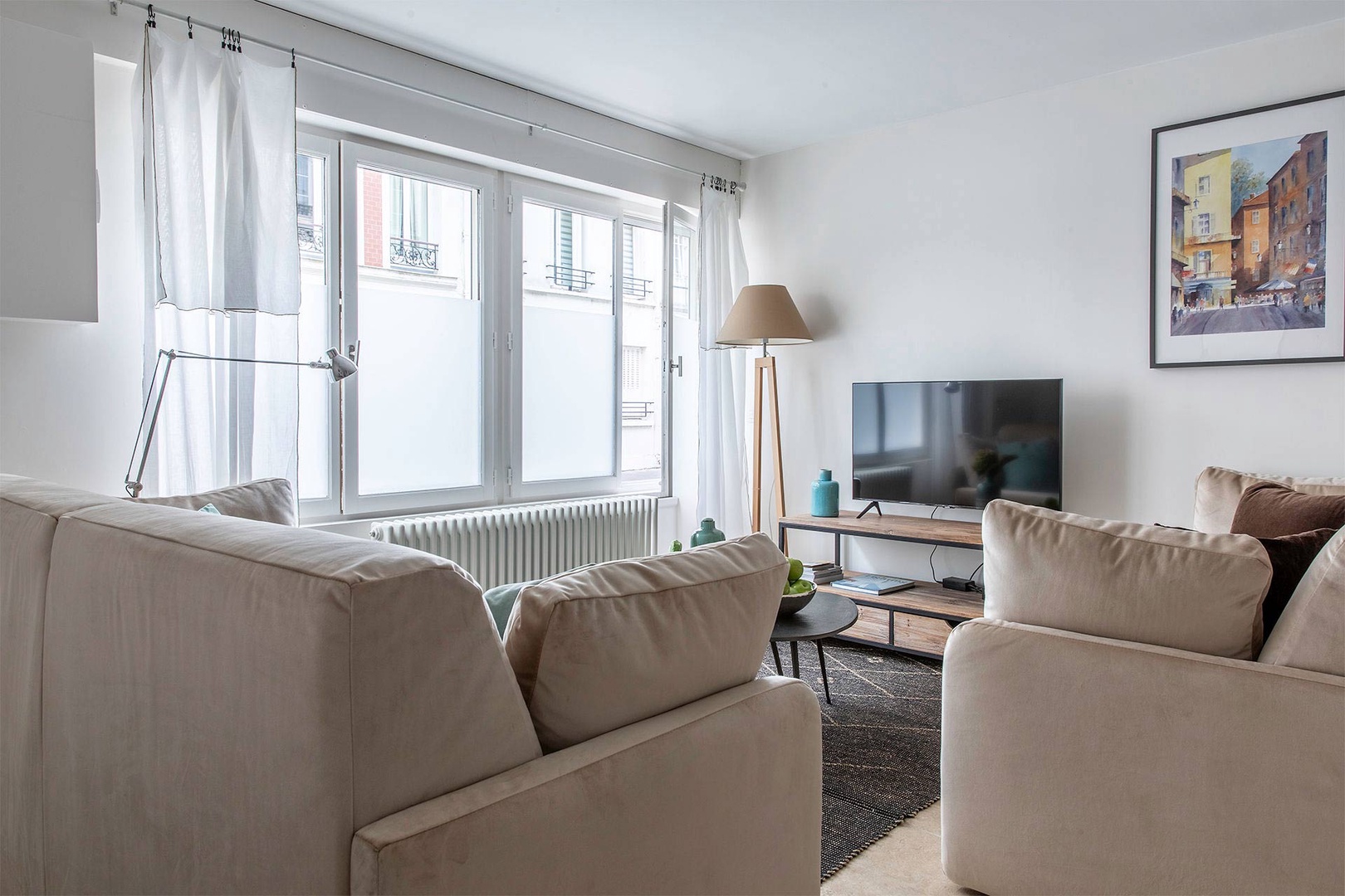 Large windows fill the living room with light.