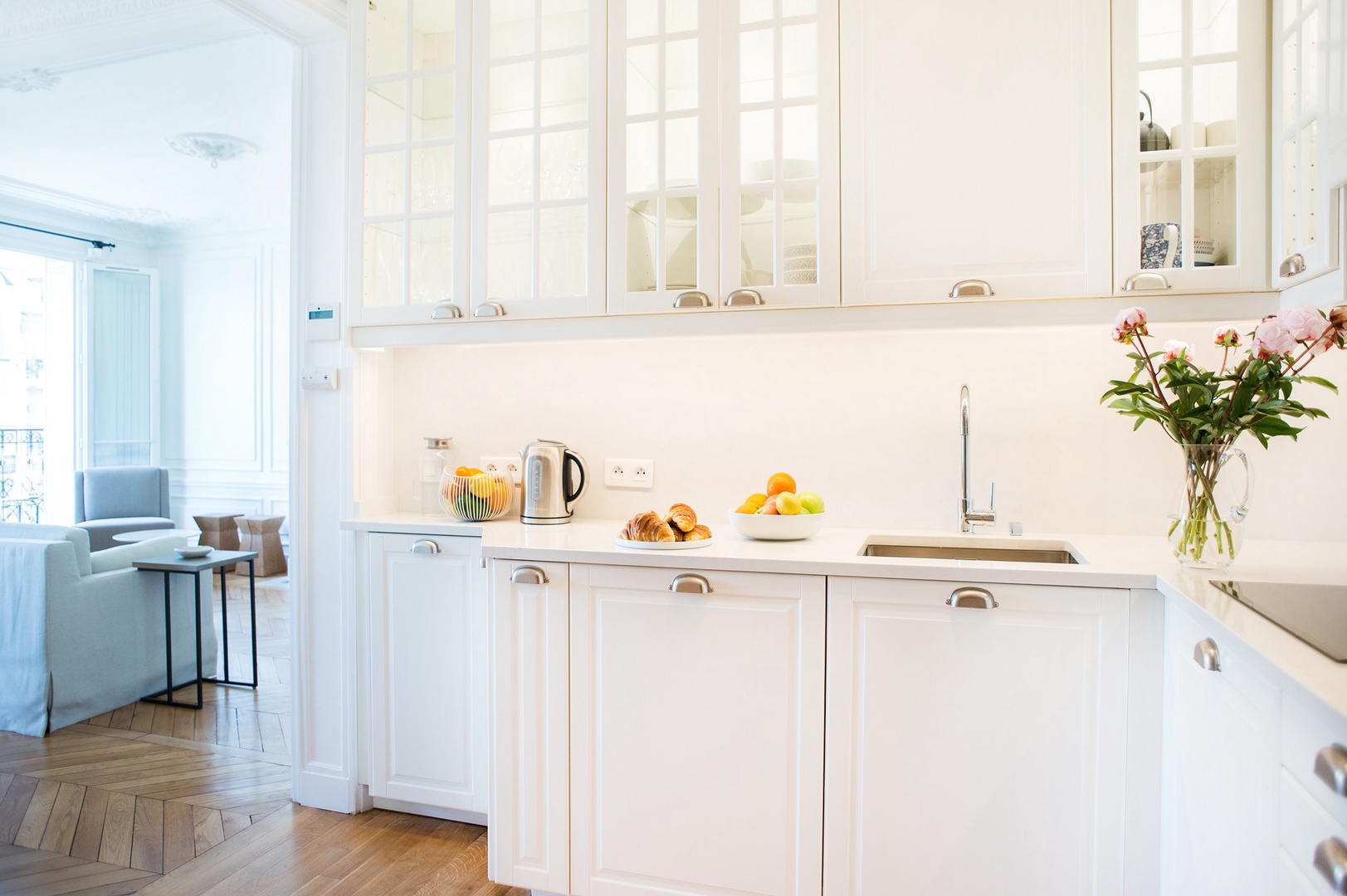 The kitchen separates common areas and private bedrooms.