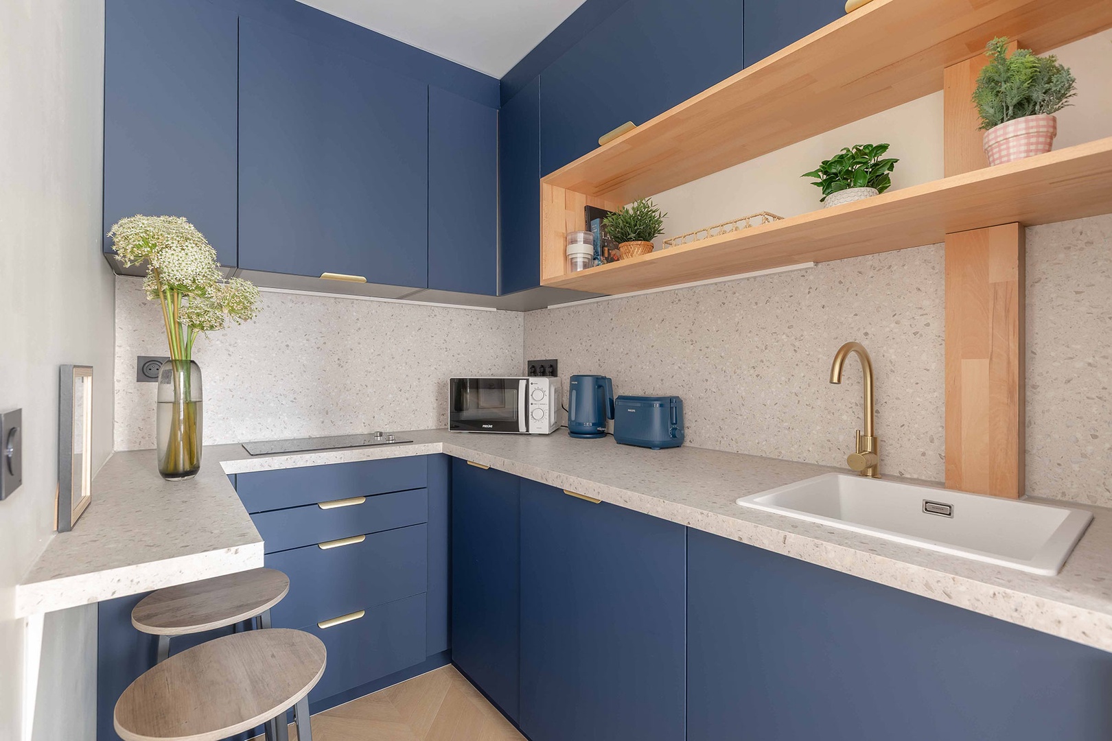 Stylish kitchen with great room plus a bar and stools.