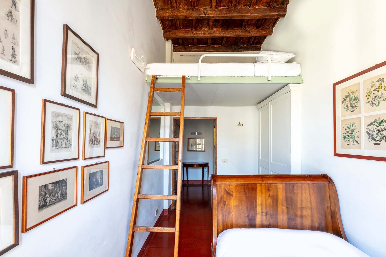 A ladder leads up to an additional bed in bedroom 4.