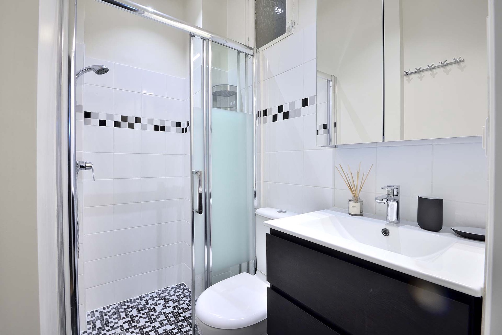 Modern bathroom with shower, toilet and sink.