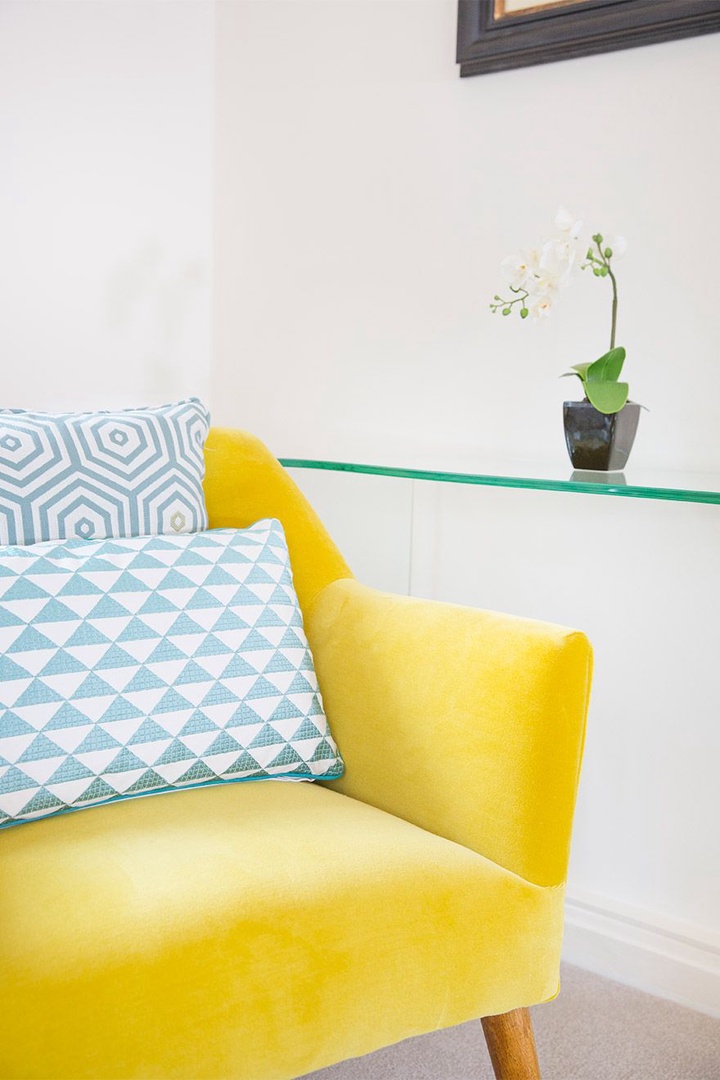 Fun yellow and blue colors liven up the living room