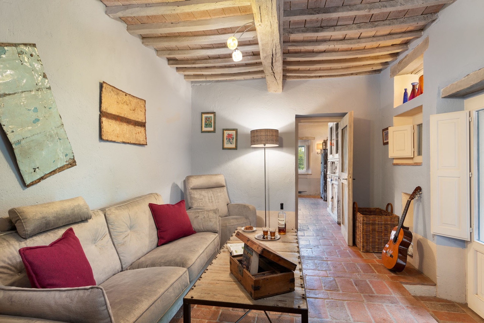 Sitting room just off the dining area has a TV and books opening to the pergola