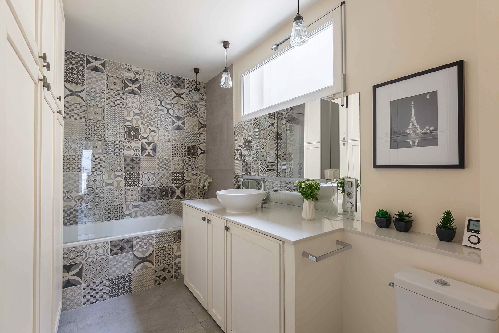 Beautiful tile lined bathroom with combination bathtub/shower.