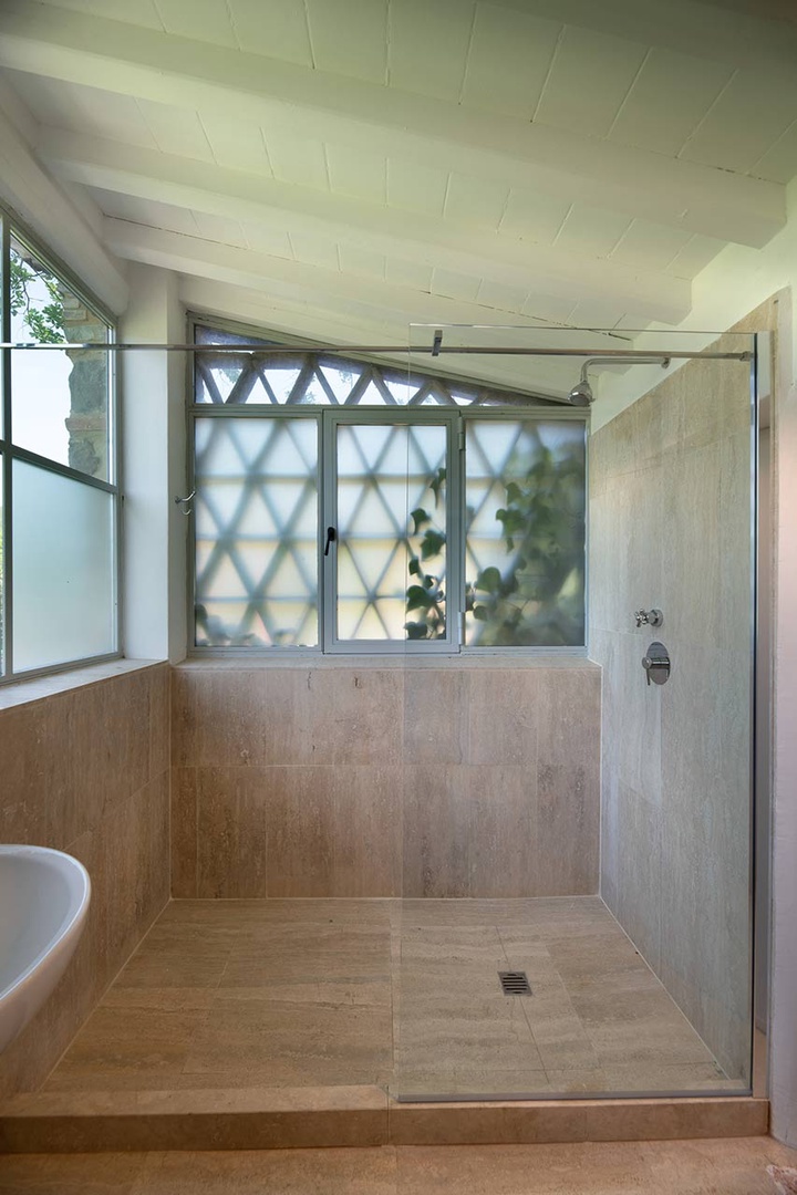 Studio bathroom with shower, sink and toilet.