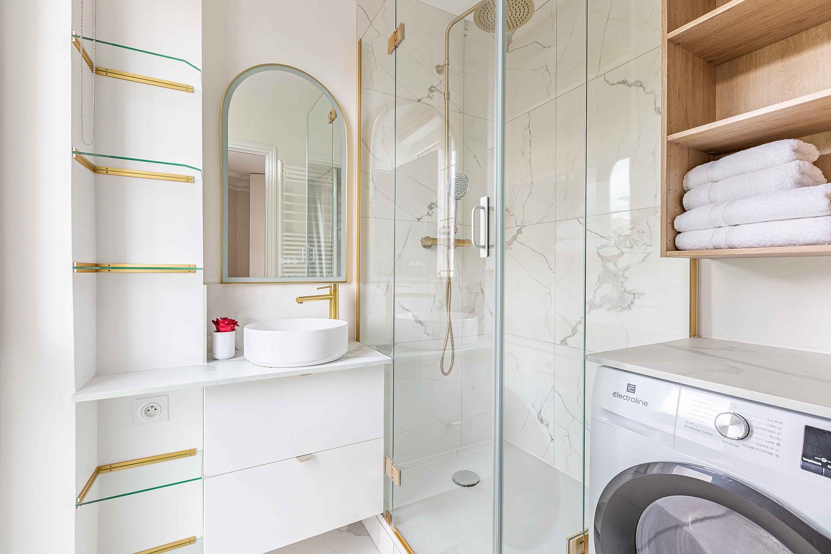 En suite bathroom has shower, sink and washer/dryer combo.