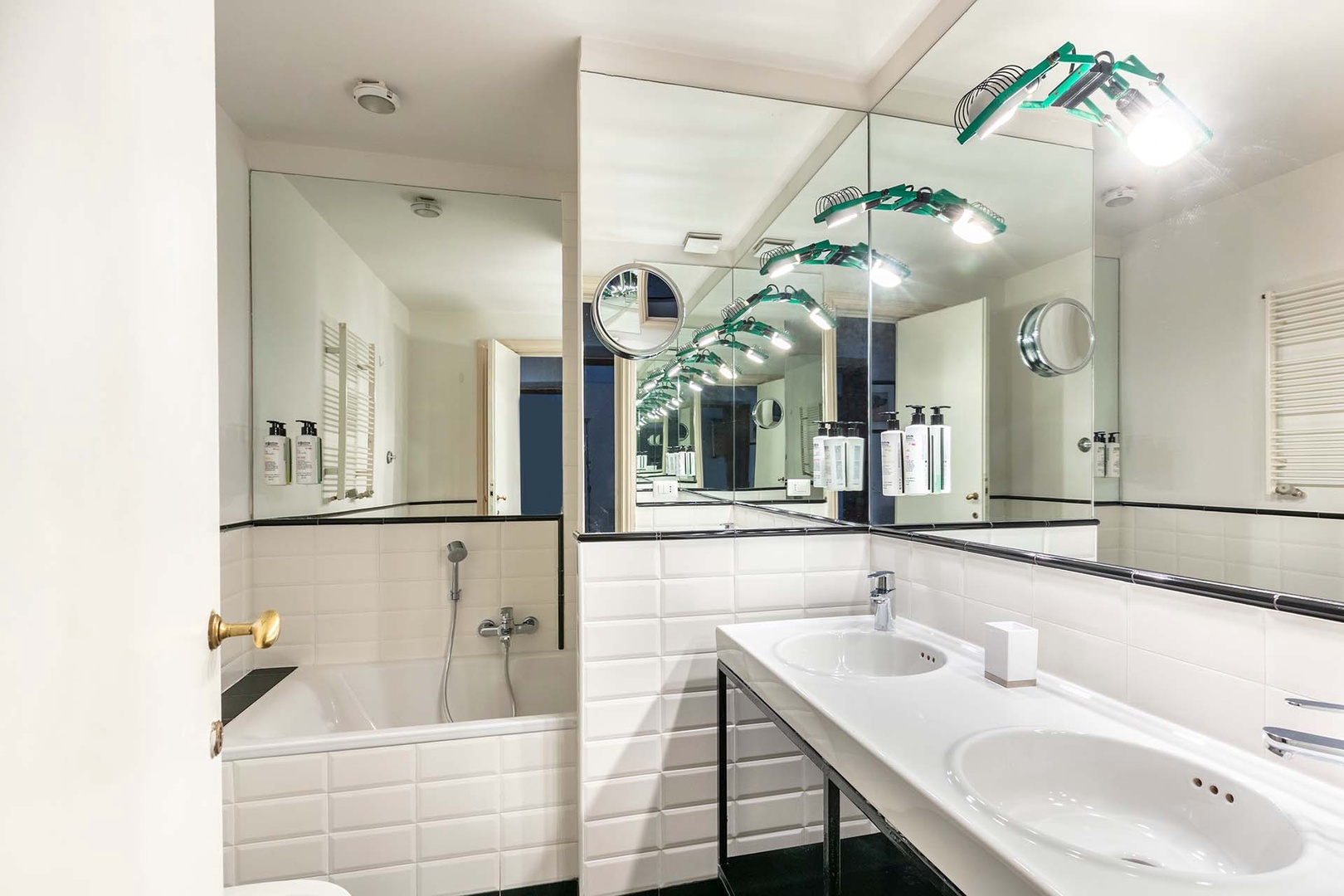 Bathroom 1 with double sink and combination bathtub/shower.