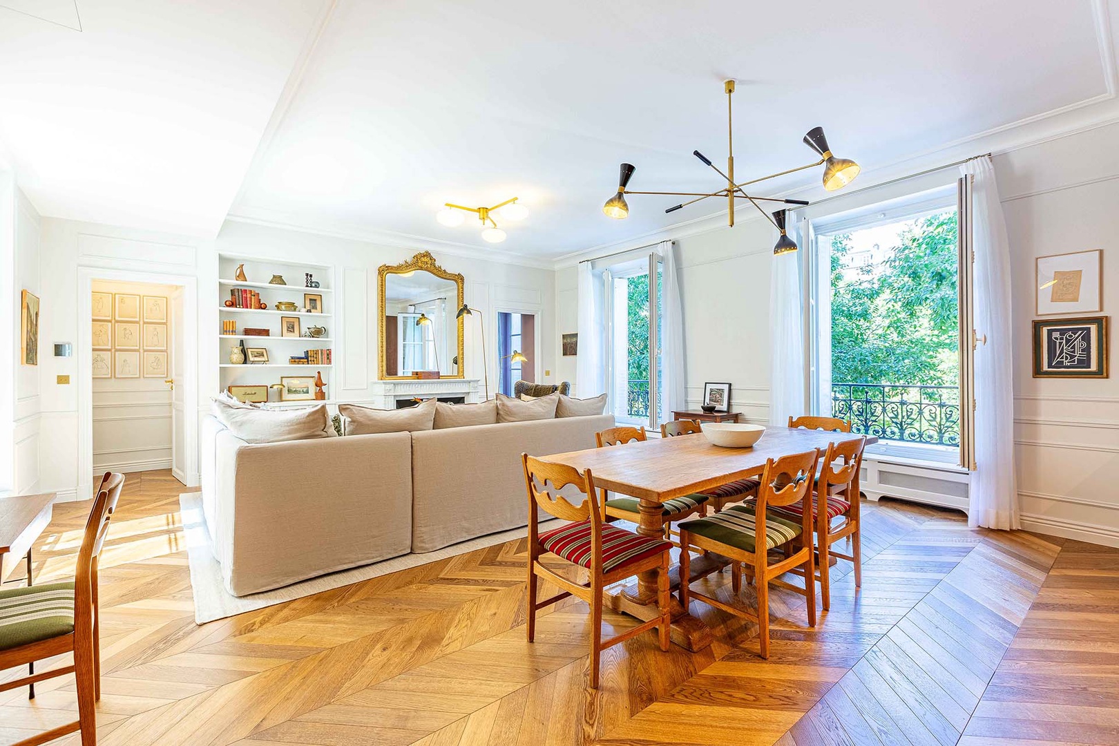 Large windows overlook a tree-lined street.