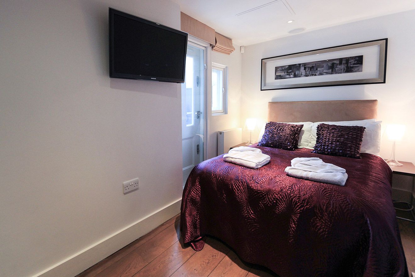Second bedroom with a comfortable bed and flat screen television
