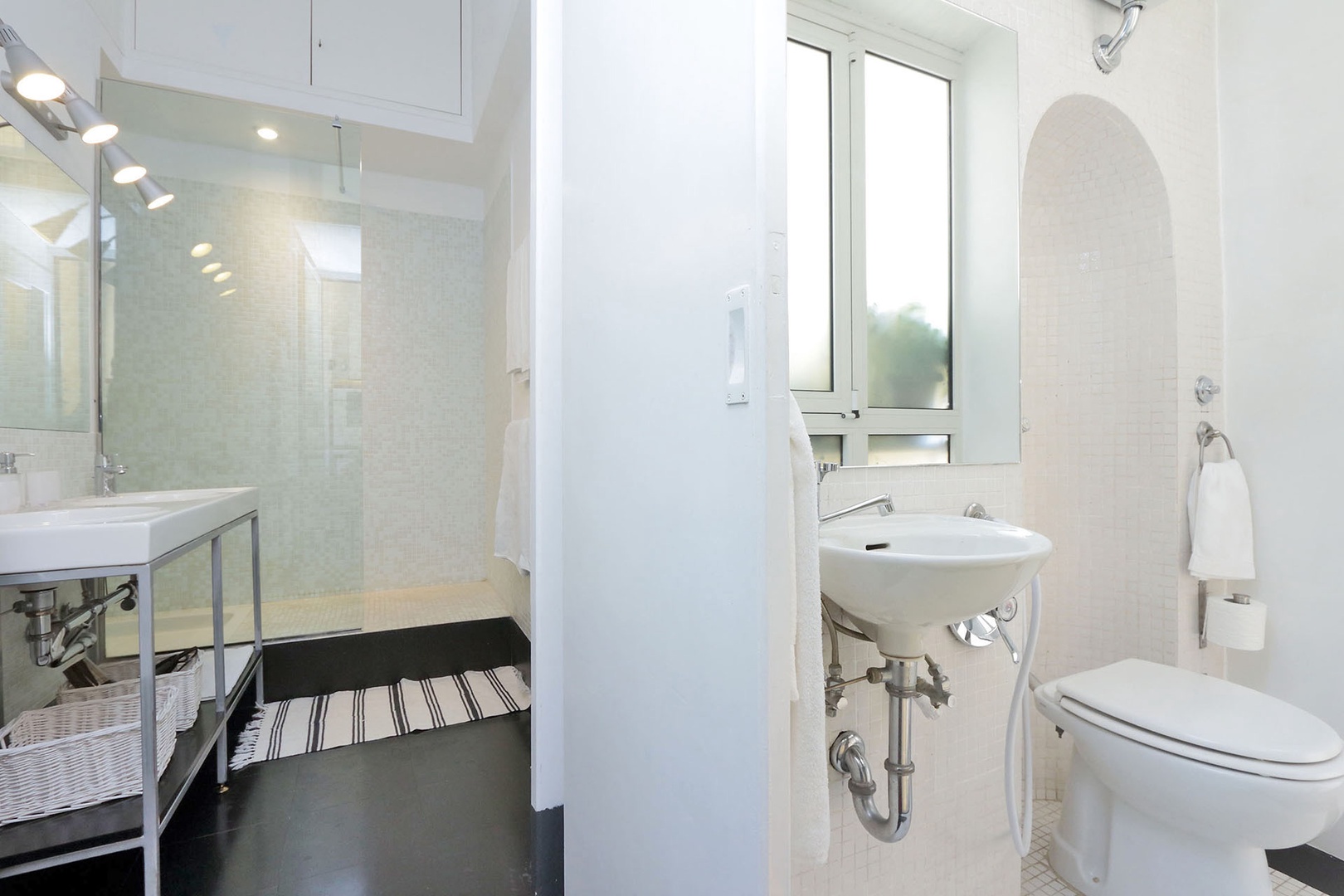 Bathroom 4 has double sinks and a large glassed-in shower. Accessed off the kitchen.