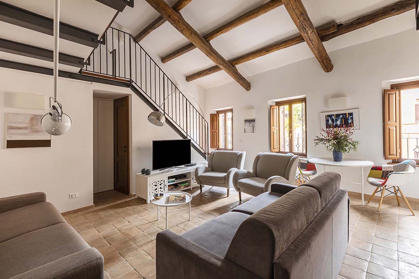 Light filled living area with wood beamed ceiling.