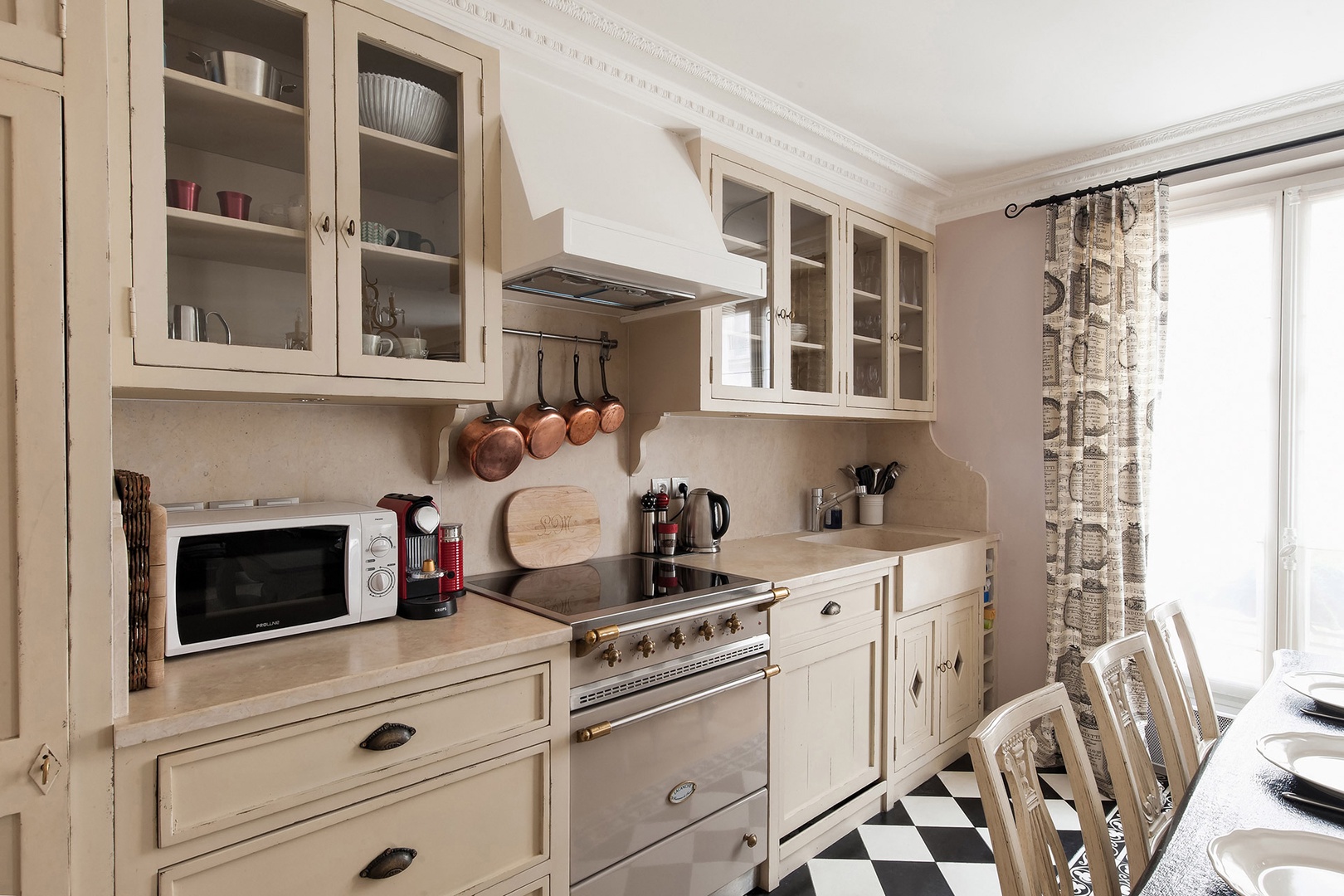 Sunlight streams into the beautiful Parisian kitchen.