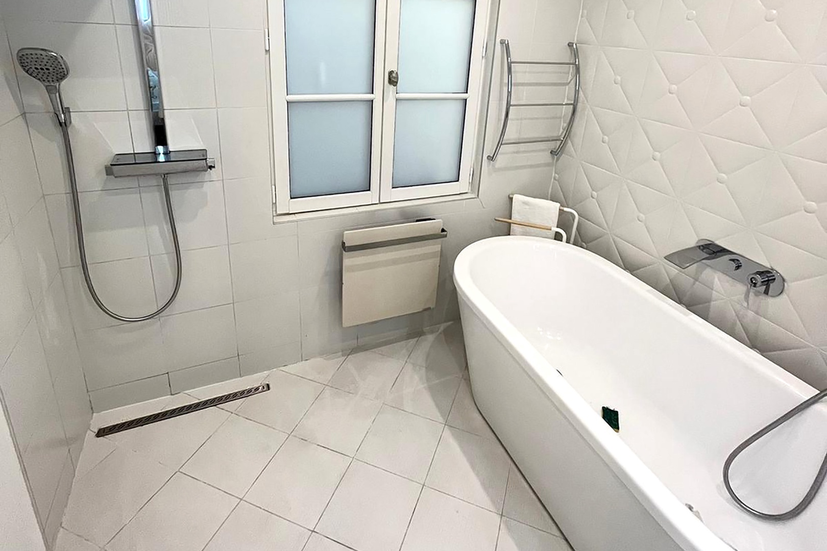 En suite bathroom with large bathtub and shower.