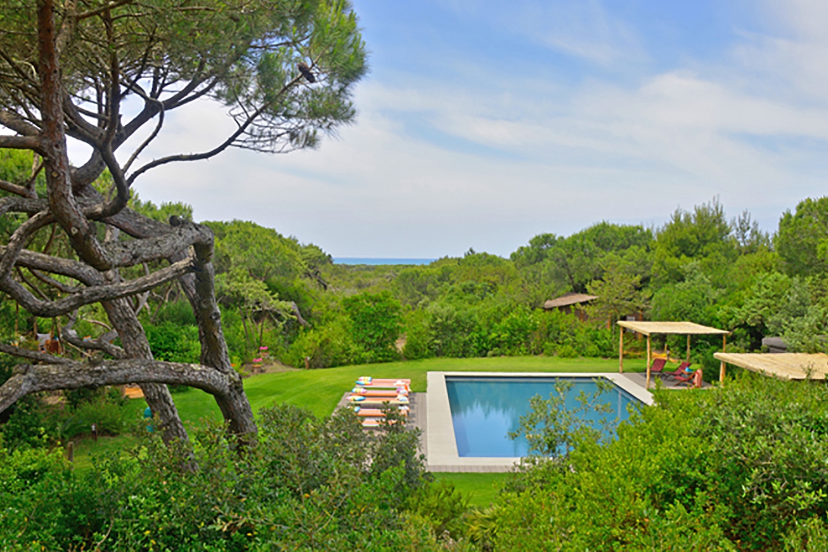 Sparkling swimming pool with the gorgeous blue Mediterranean sea in the backdrop.