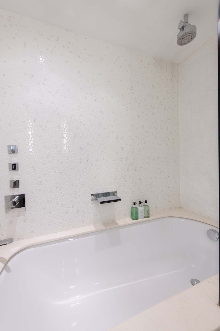 Bathtub and shower combo in bathroom 3.