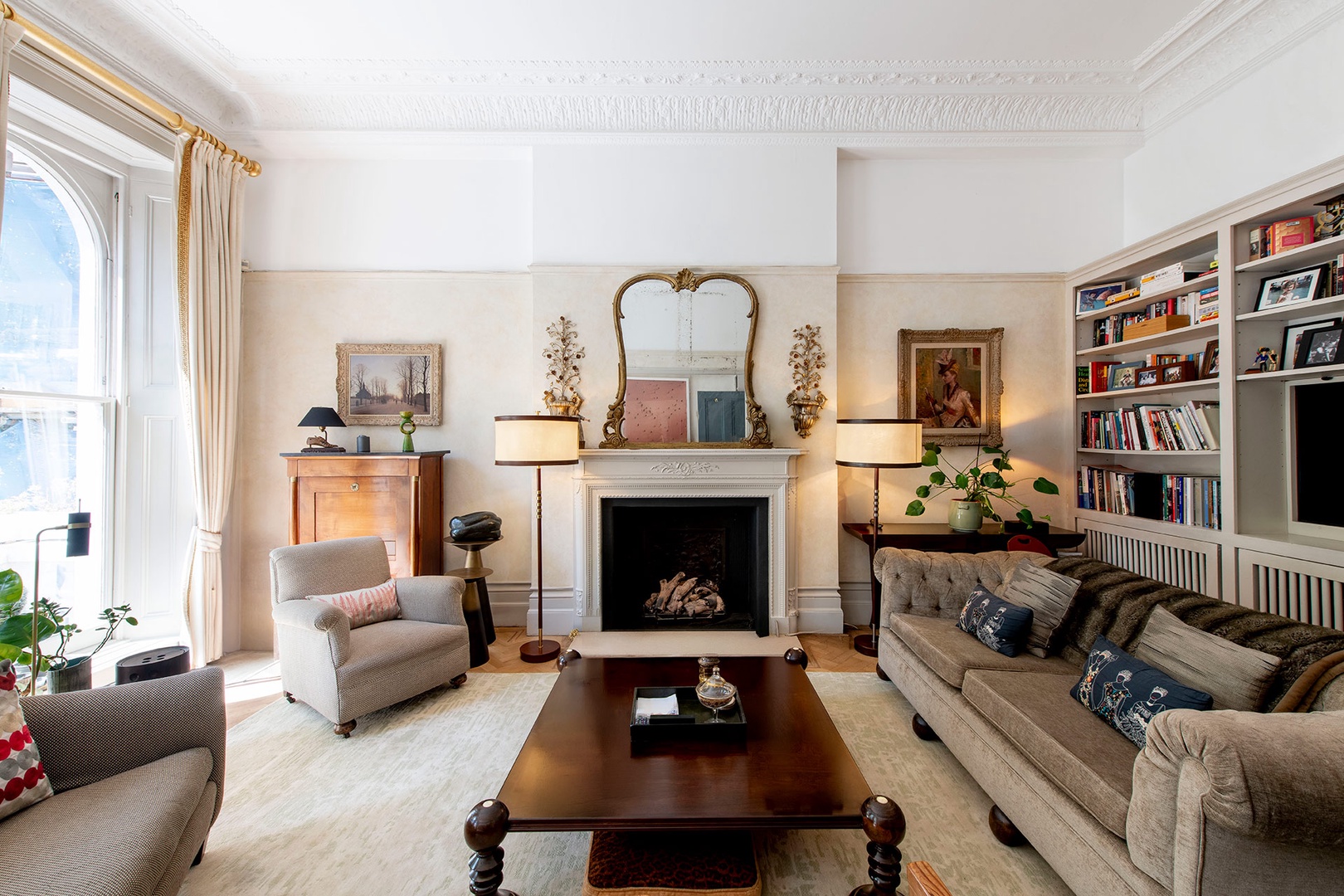 Cozy living room with fireplace and antique mirror.