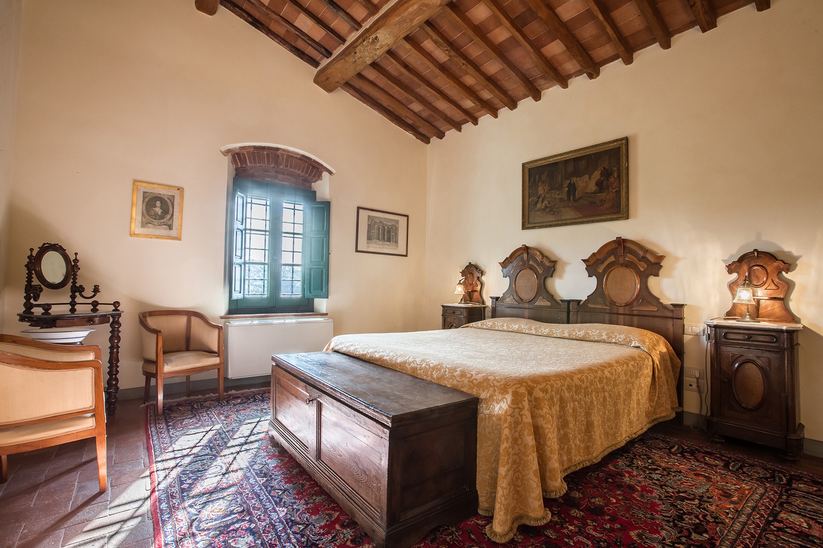 Bedroom 1 features a comfortable bed with intriguing Louis Philippe Tuscan headboards.
