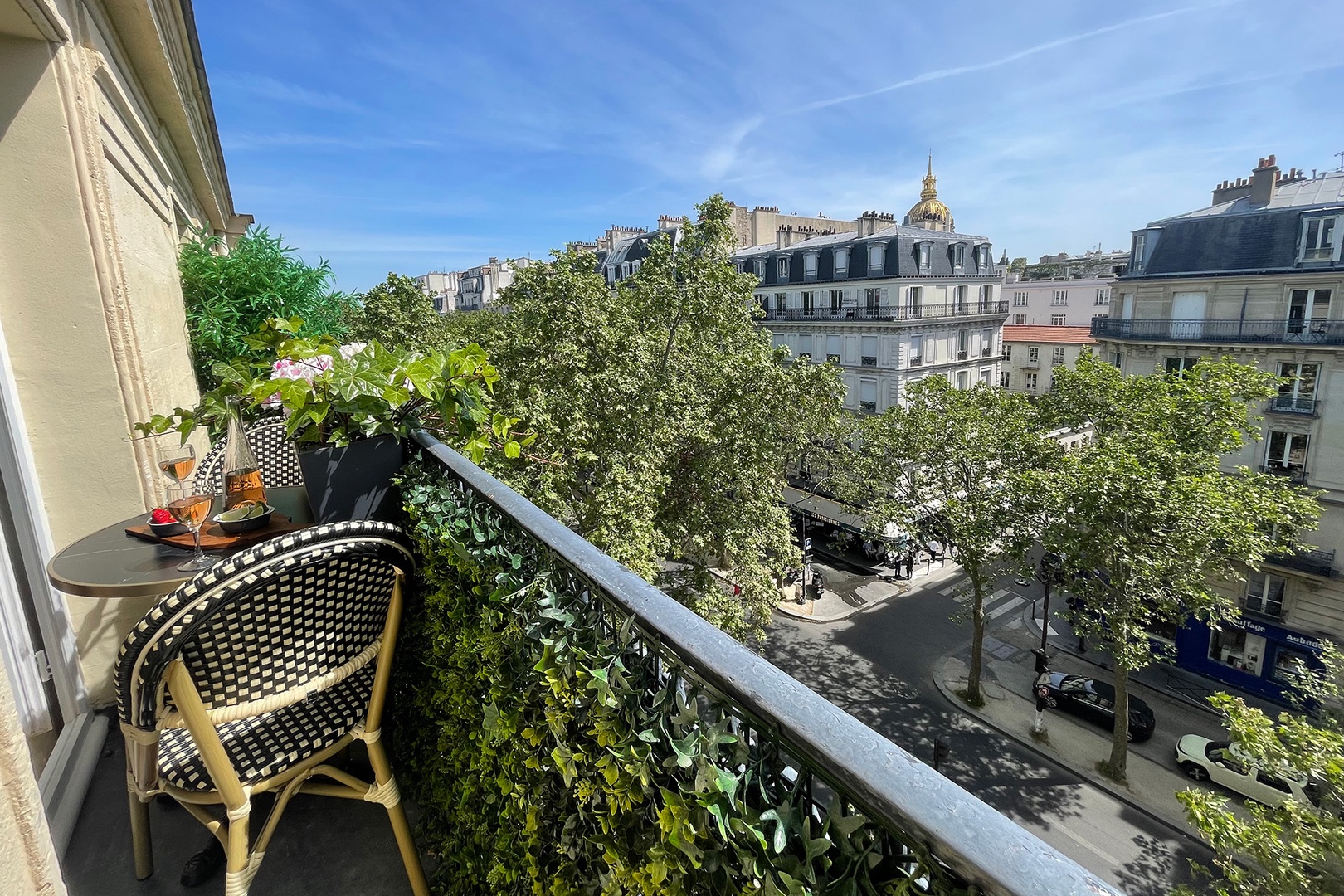 Long balcony has two bistro tables.
