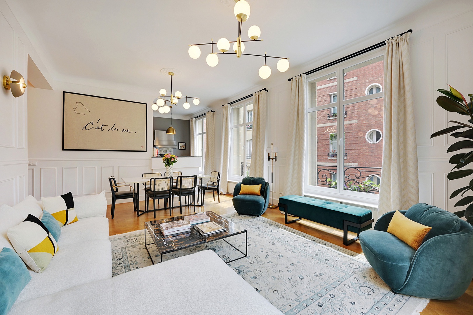 Large windows fill the open plan living room and dining area with light.