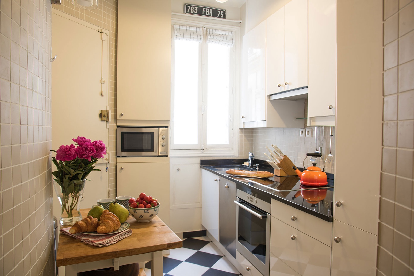 The fully equipped kitchen comes with modern appliances.