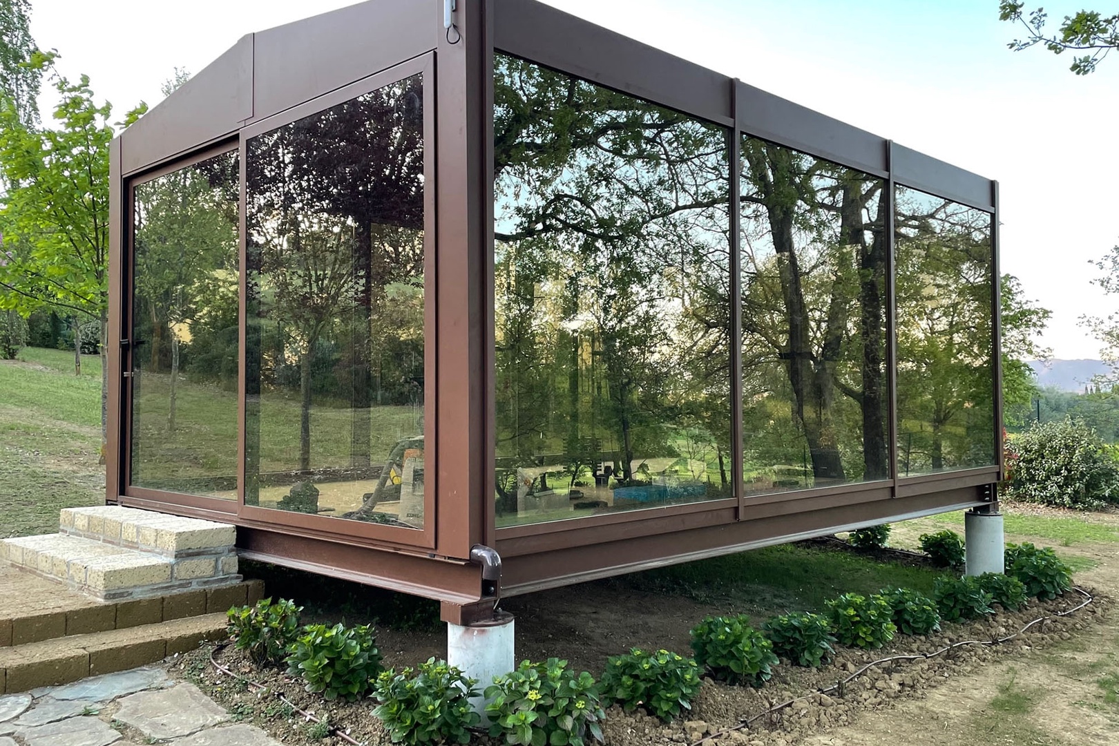 Glass-walled gym gives the sense of exercising surrounded by nature.