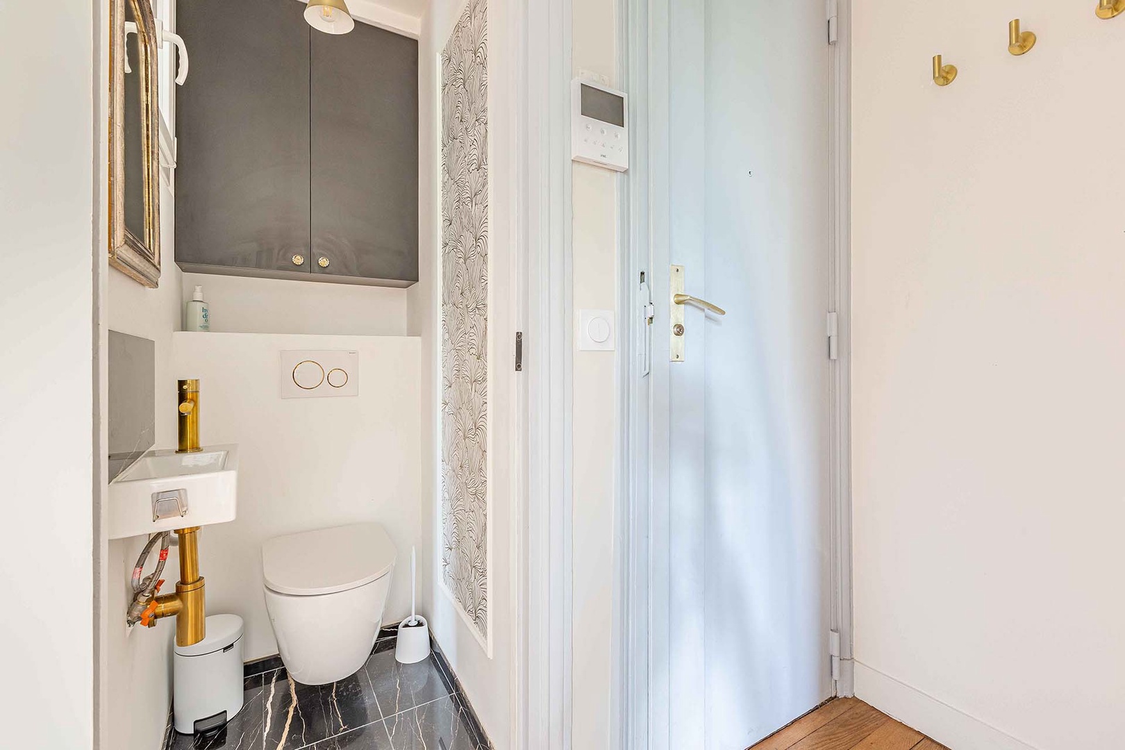 Powder room with toilet is located near living room.