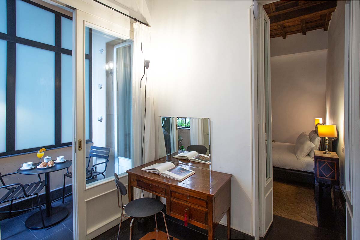 Small desk in bedroom one just outside the covered balcony