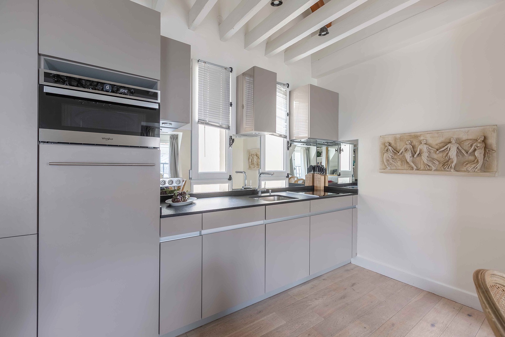 Tall windows create a light-filled setting in the kitchen.