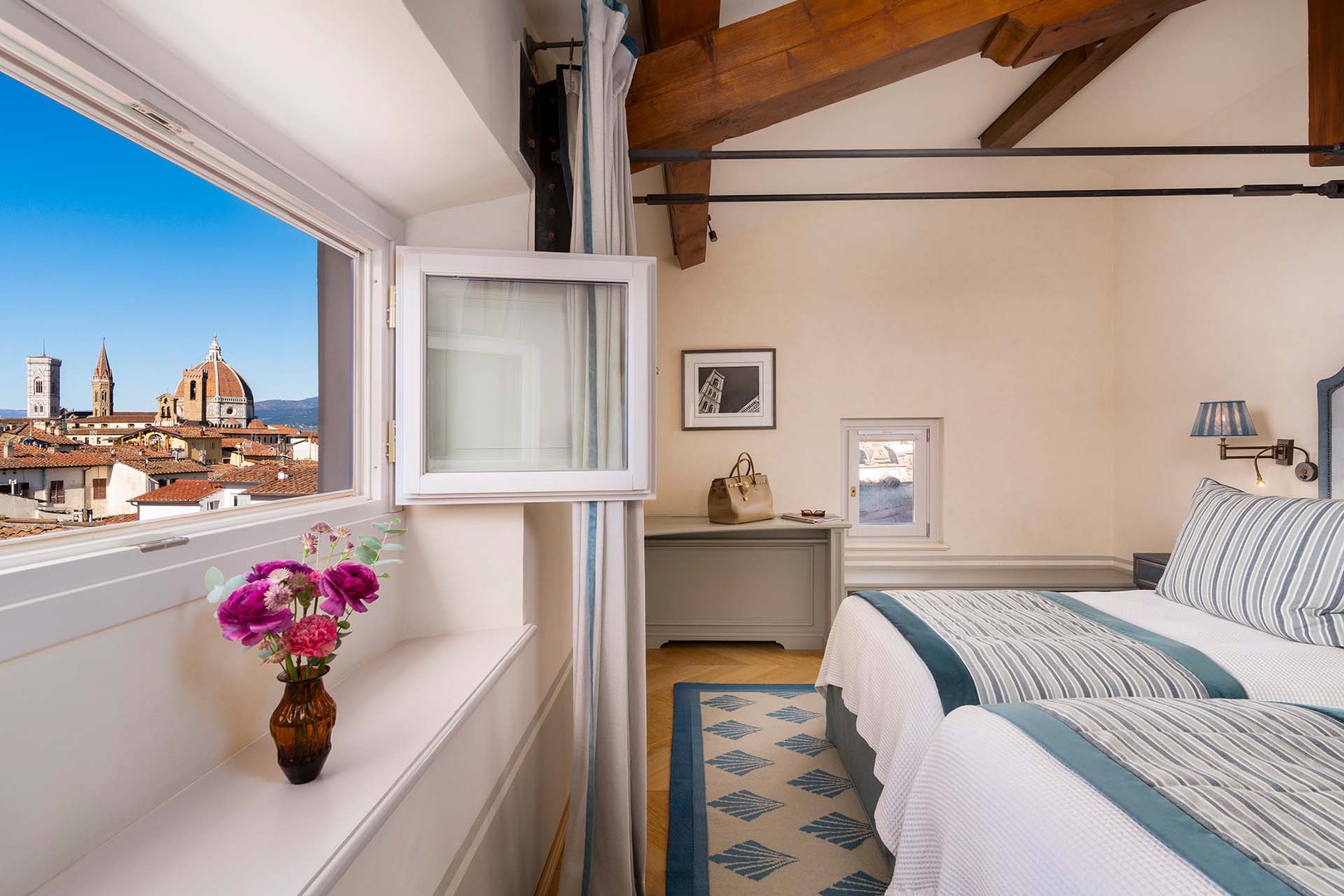 Wake up to Florence's iconic Duomo framed perfectly in your bedroom window, where rustic beams meet elegant comfort.