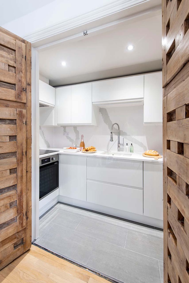 Rustic doors open to the fully equipped modern kitchen.