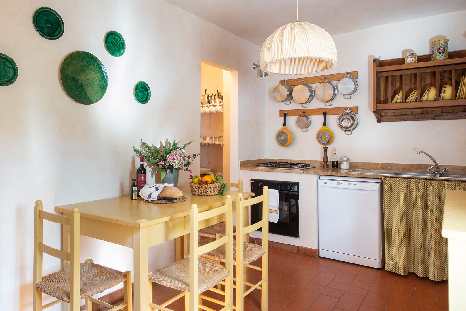 Eat-in kitchen looks over the sun-drenched courtyard. Dining table seats 4.