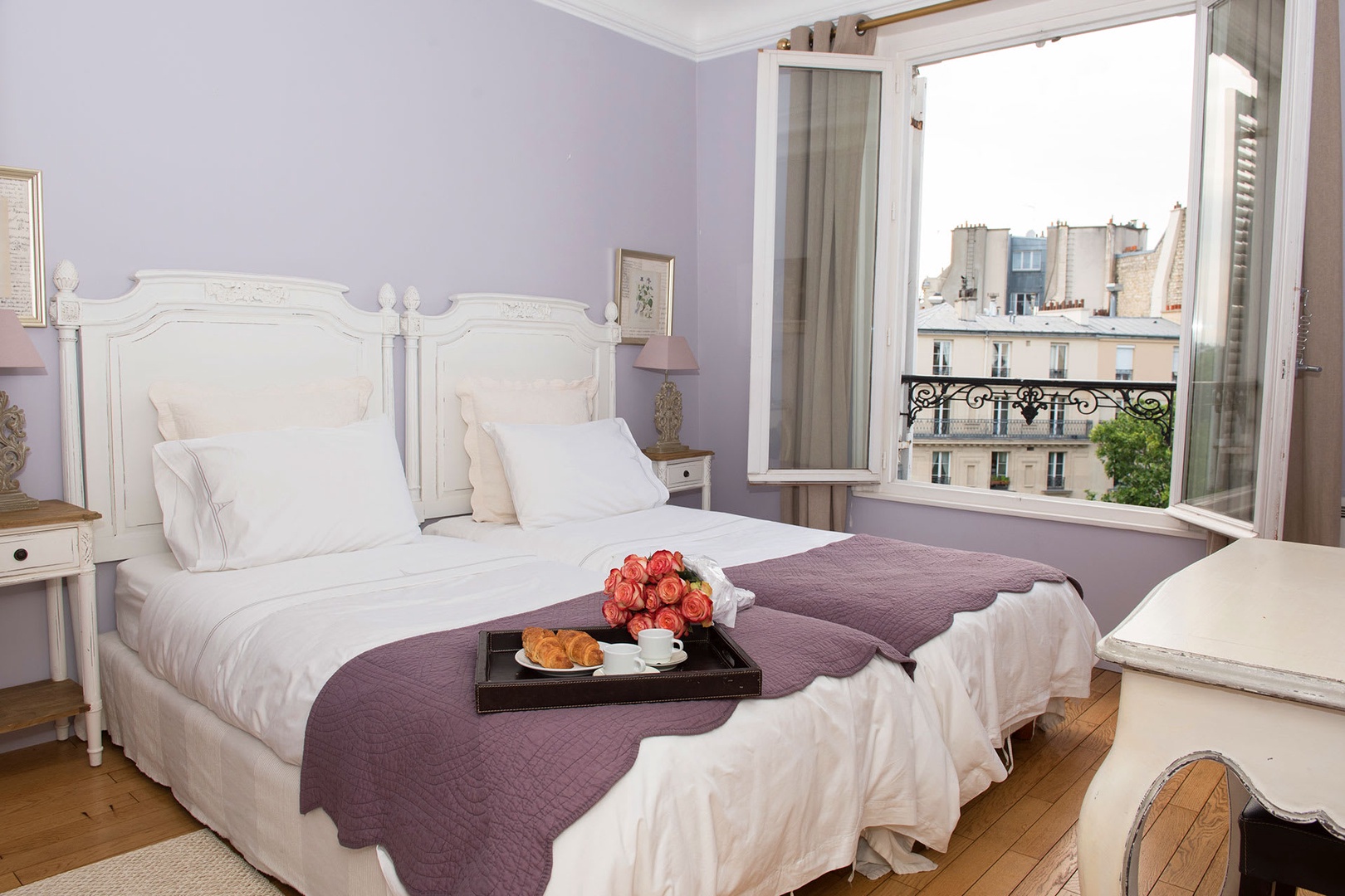 Bedroom 2 has comfy beds and an Eiffel Tower view.