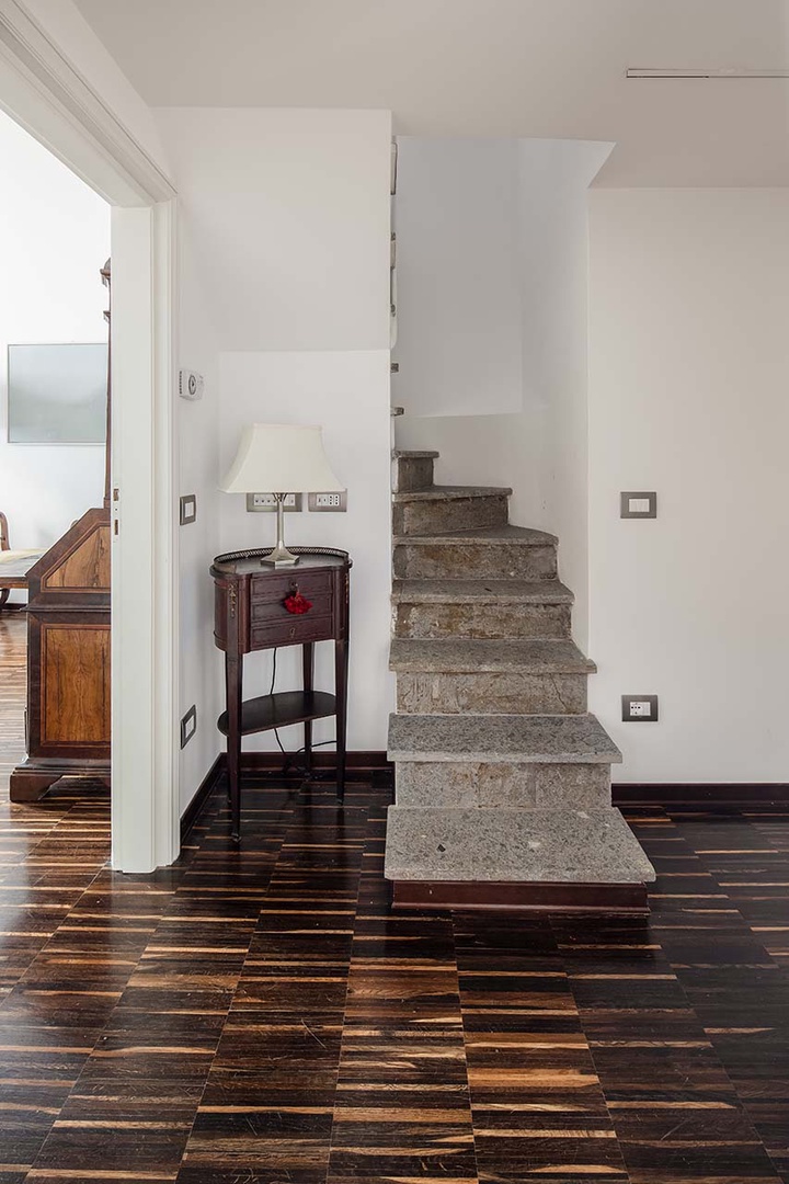 Steps lead to upper level to reach bedroom 2 and loft.