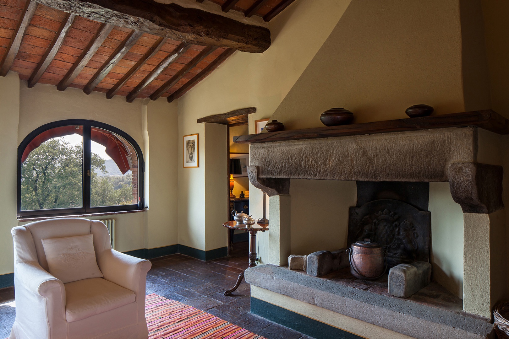 Cozy sitting room on the 2nd floor has an open fireplace, a perfect spot to snuggle up with a book.