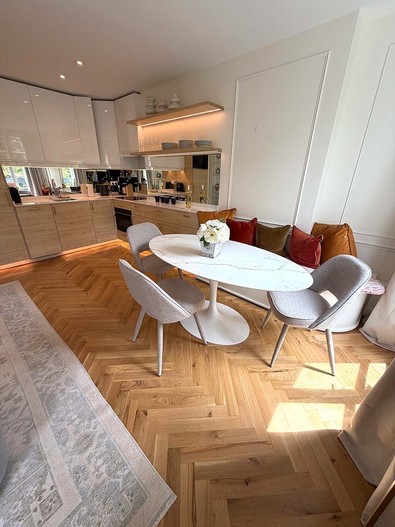 Dining table is set near the French doors to capture the view.