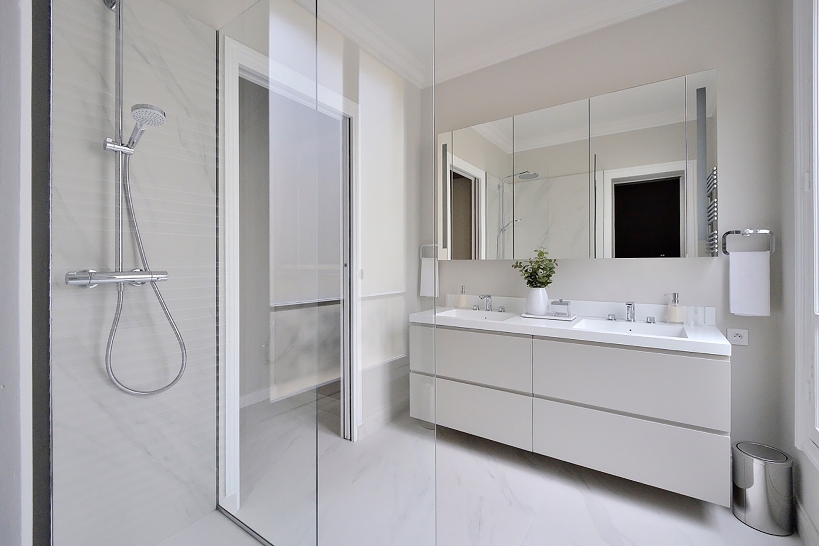 En suite bathroom in Bedroom 1 with shower and double sink.