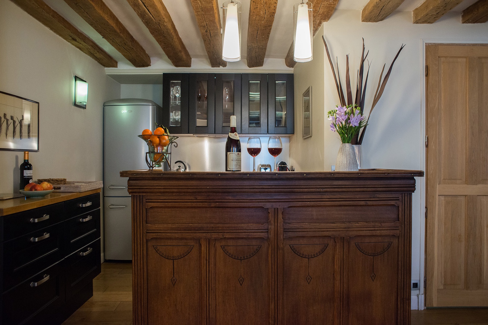 The kitchen also includes a classic bar area, perfect for apero hour.
