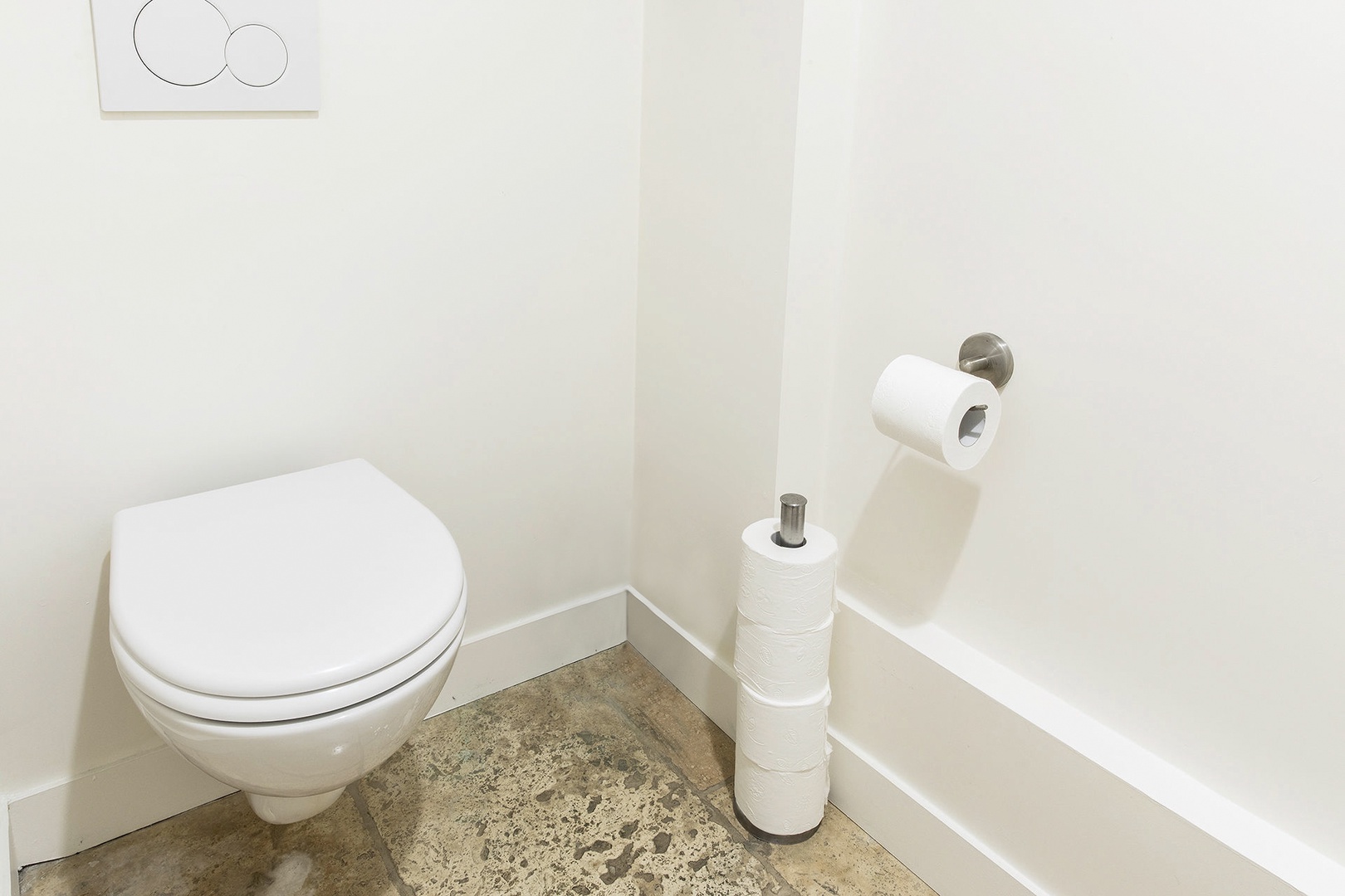 Half bath with toilet off the kitchen.
