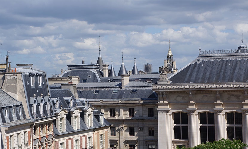 View of Paris rooftops and the spires of the Conciergerie